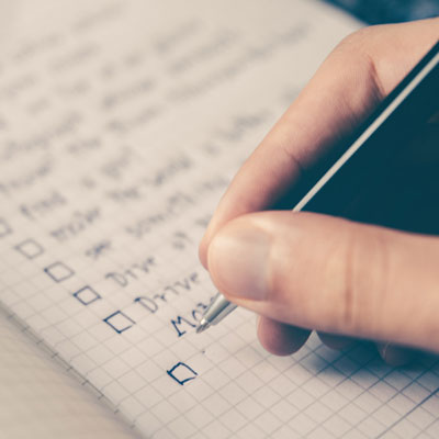 Person filling out a checklist